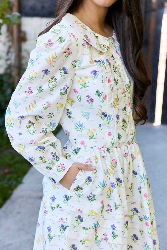 Woman wearing a floral dress with a blurred background - botanical peter pan collar floral cottagecore feminine spring easter outfit soft girl aesthetic outfit