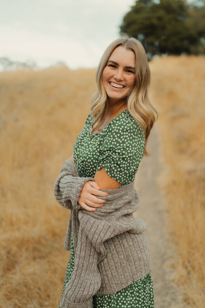 green dress with sweater over it