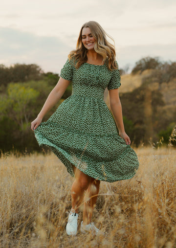 Girl in field in green midi dress